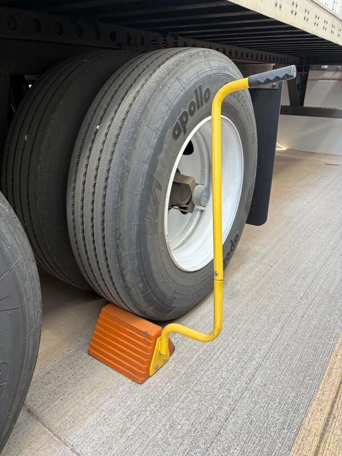 Tire lock device securing large truck wheel to ground