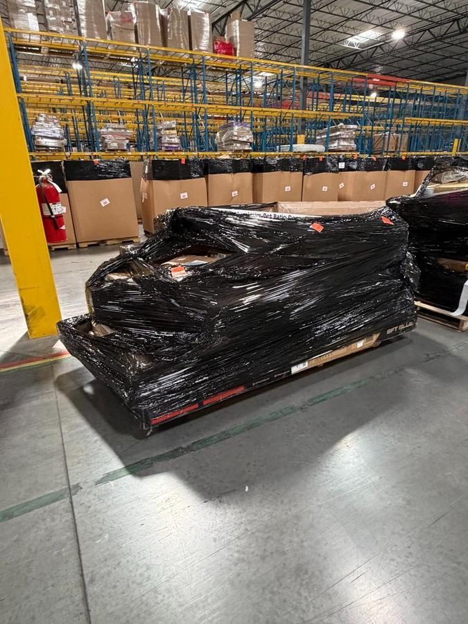 Wrapped pallet of goods in warehouse with racking and bins