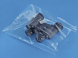 Small black mechanical part in clear plastic storage container