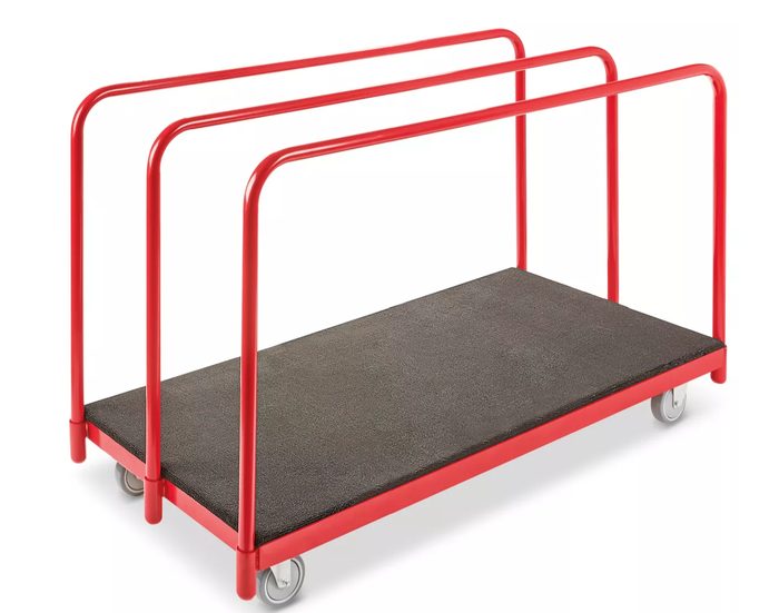 Red panel cart with dark gray cushioned platform and casters