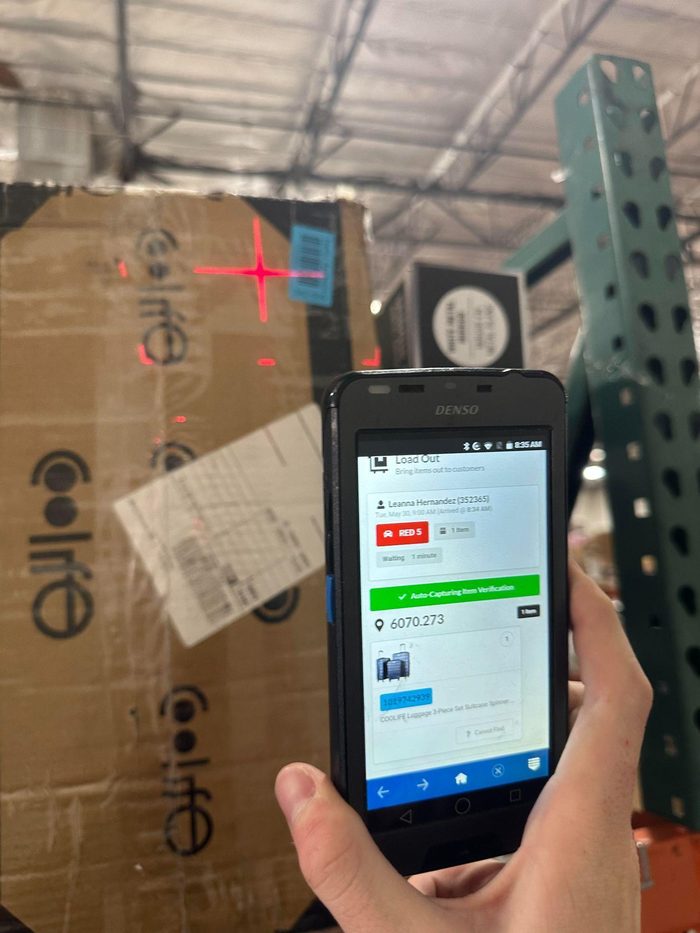 Mobile device displaying load out information in warehouse inventory system