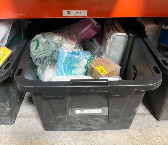 Storage tote containing miscellaneous items and packaging materials