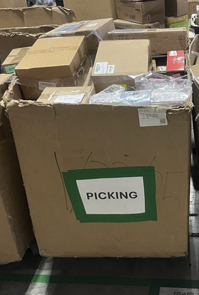 Large cardboard bin labeled "PICKING" containing sorted items