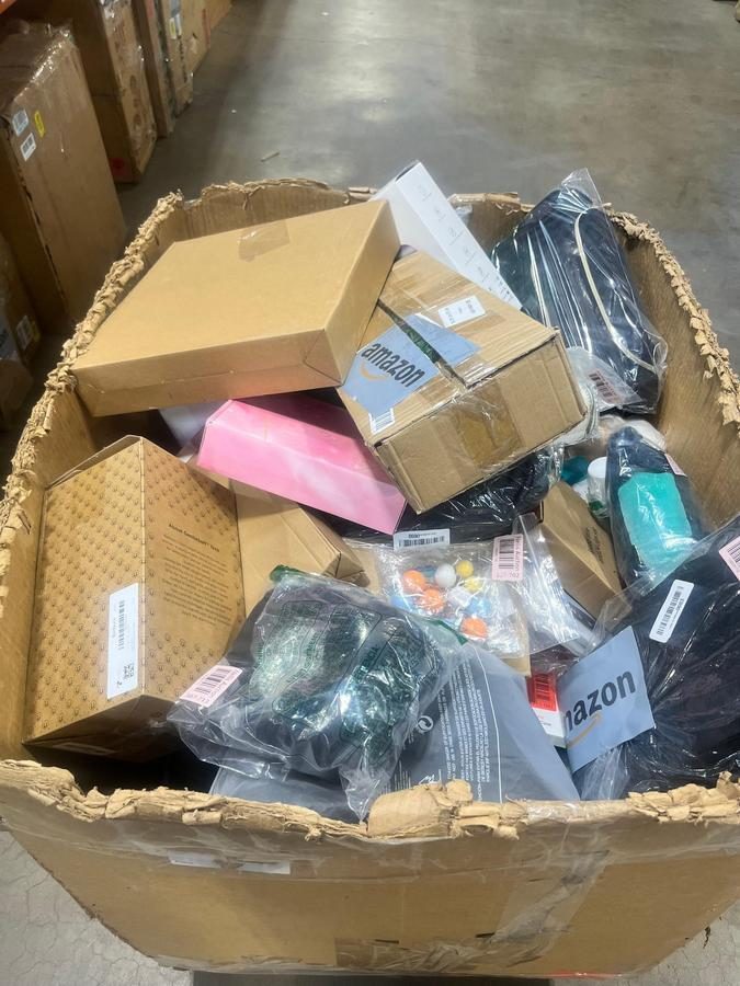 Large bin containing mixed packaged items and Amazon merchandise returns