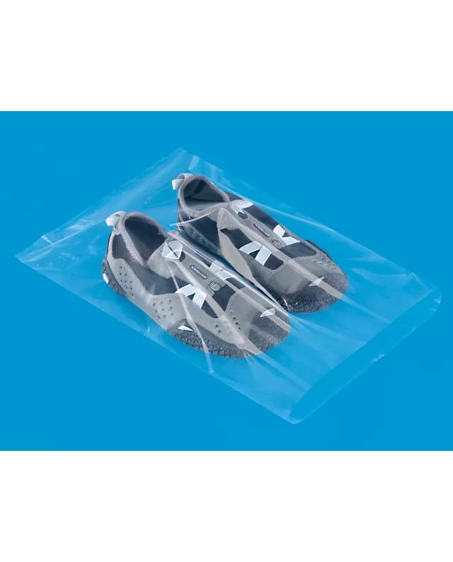 Pair of athletic water shoes in clear plastic packaging on blue background