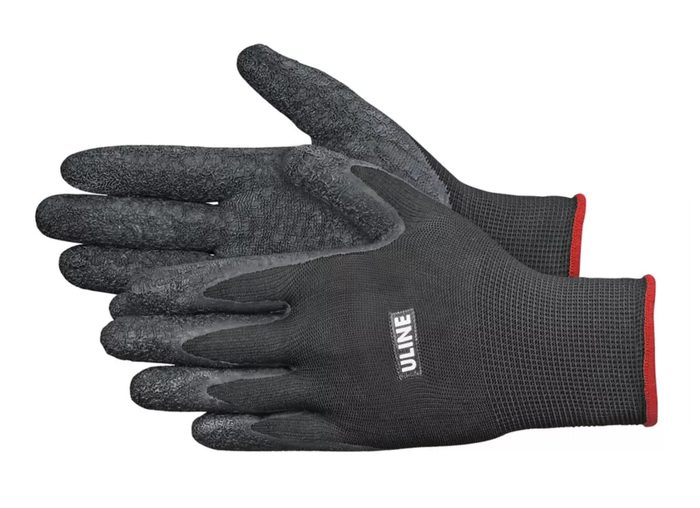 Work gloves with textured grip palms and red cuff trim