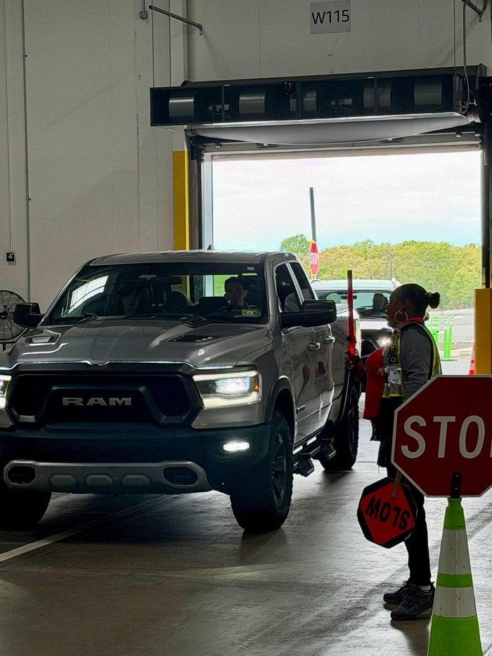 RAM pickup truck entering warehouse with stop sign control