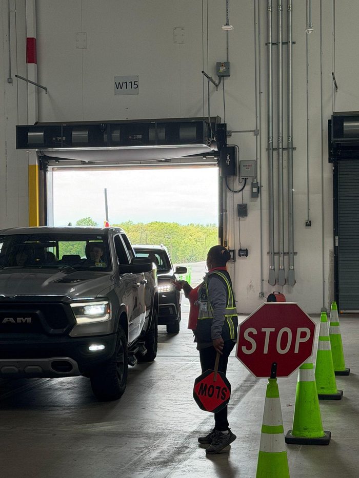 Warehouse loading bay with vehicles and traffic control safety procedures