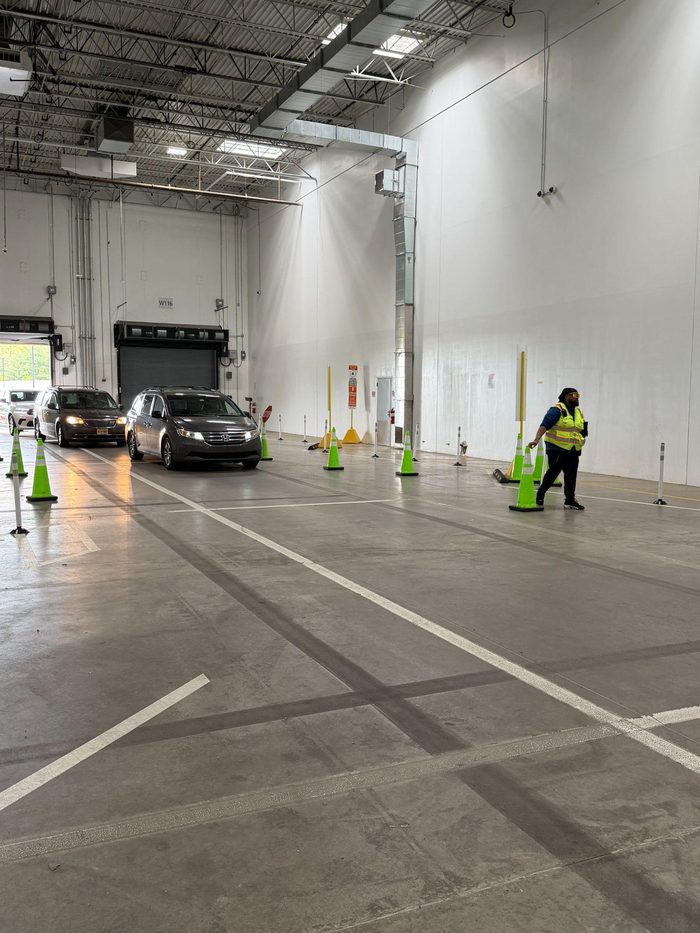 Warehouse inspection or training course with vehicles and safety cones